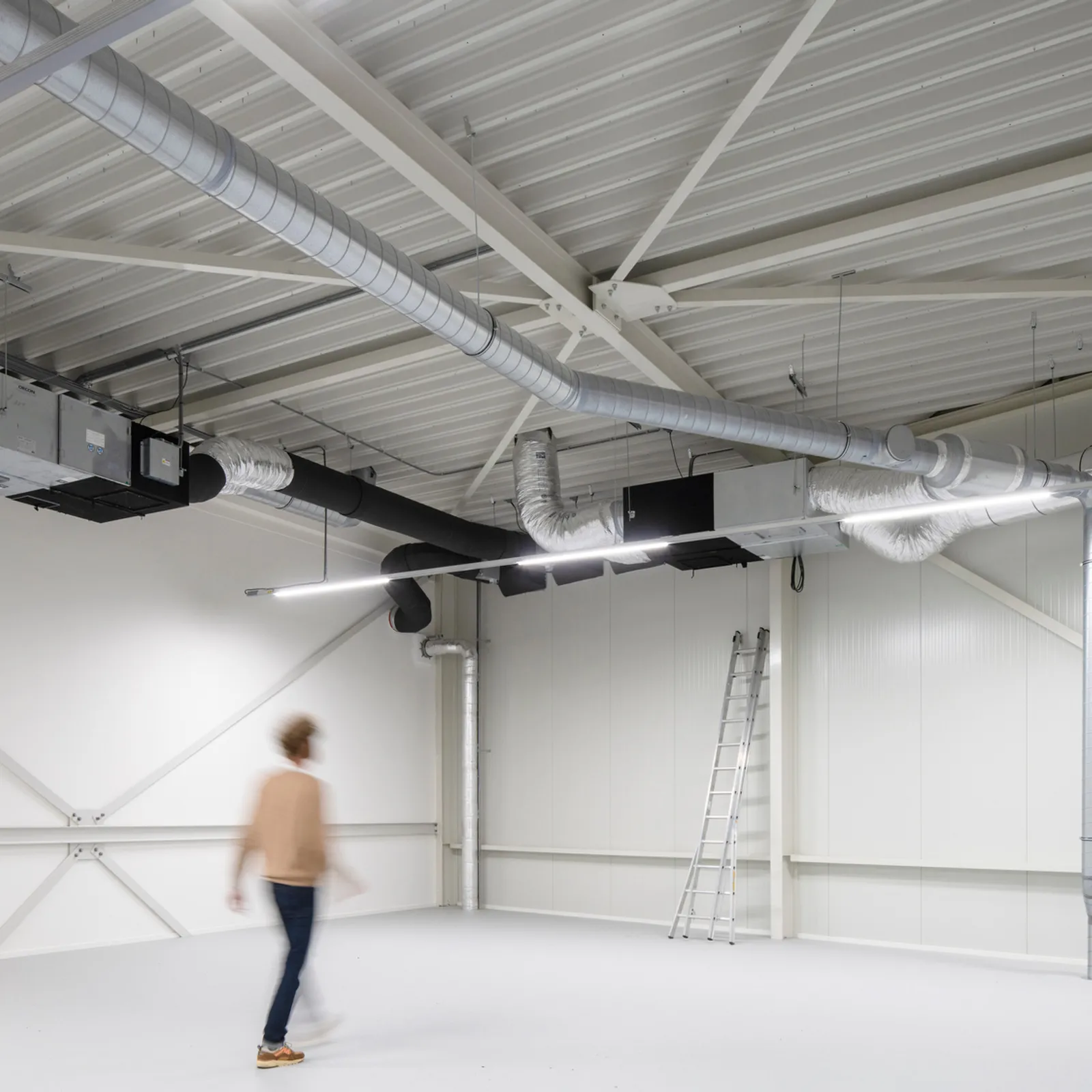 a person walking through a recent shell and core fit out