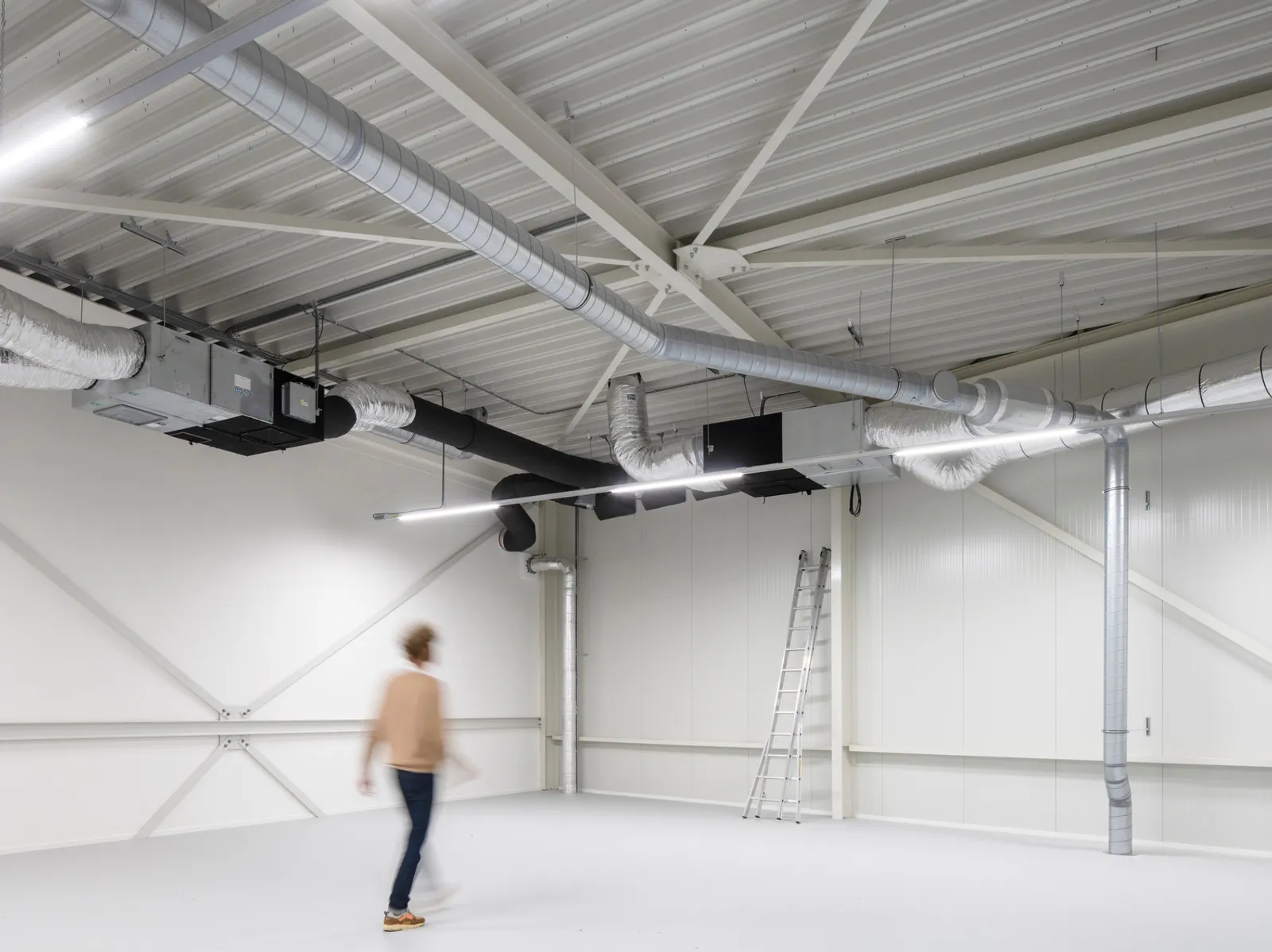 a person walking through a recent shell and core fit out