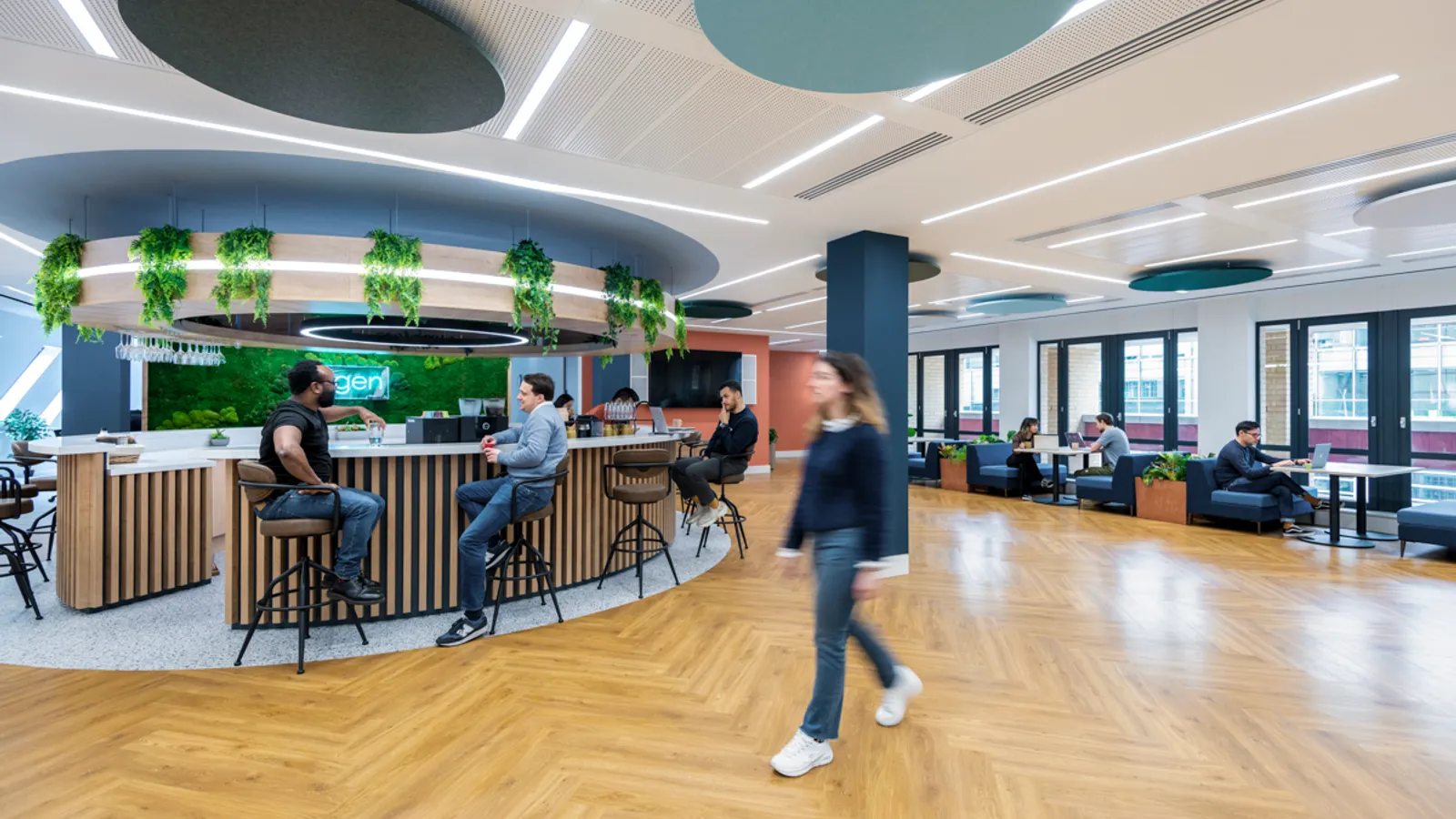 a large open hybrid office space with people working together