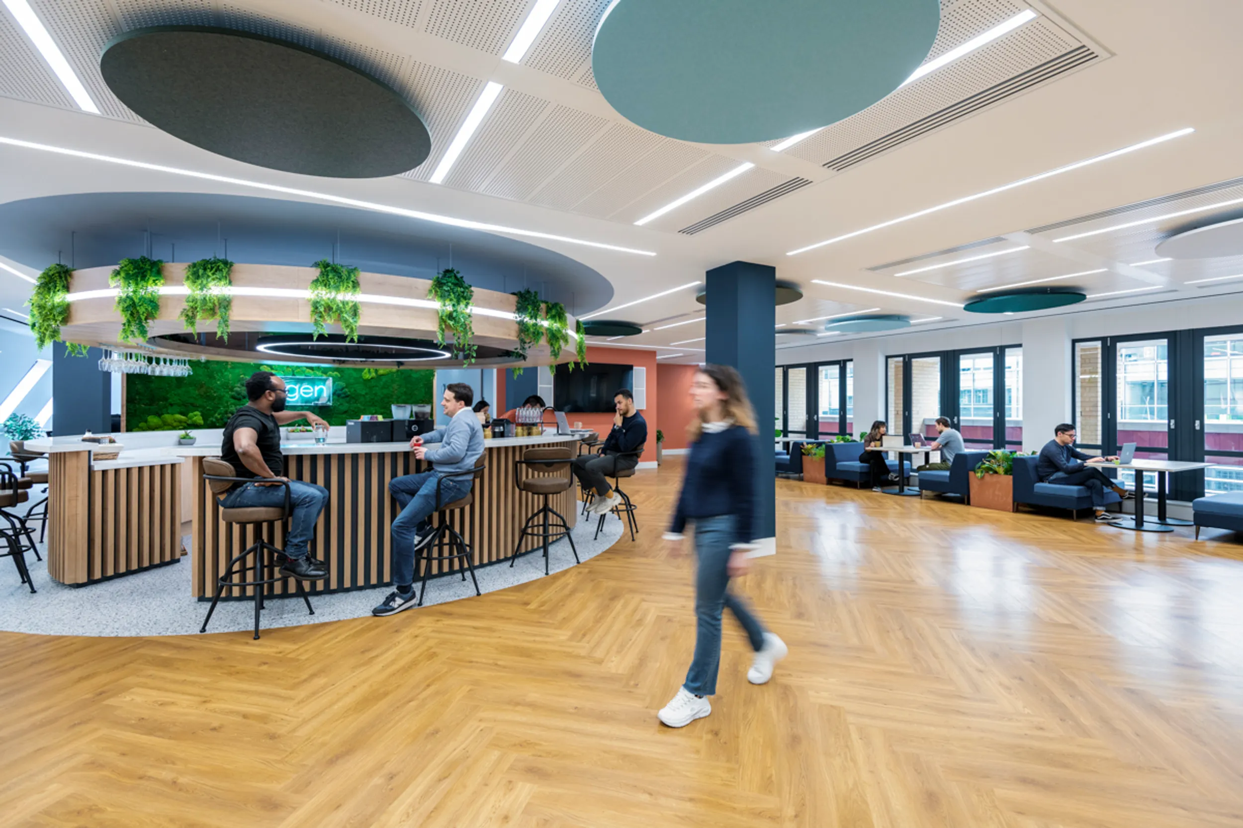 a large open hybrid office space with people working together