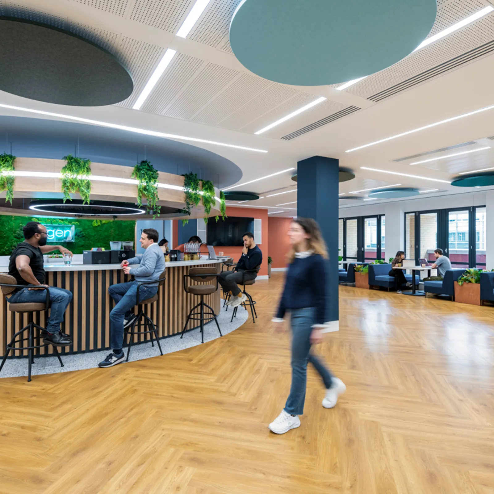 a large open hybrid office space with people working together