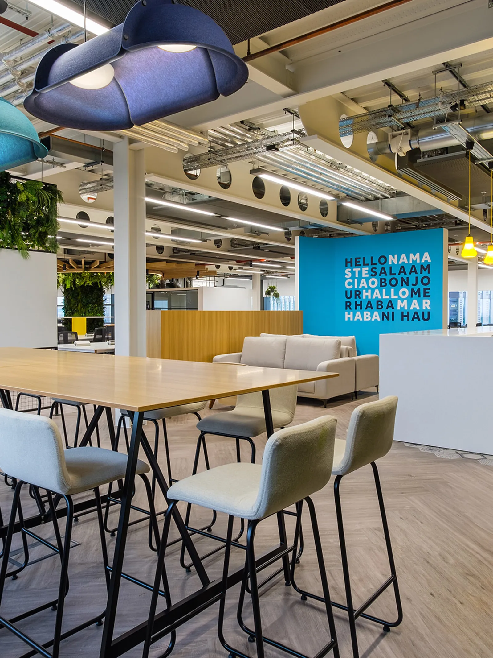 a newly fitted out office with modern furniture including sofas and a high-desk area
