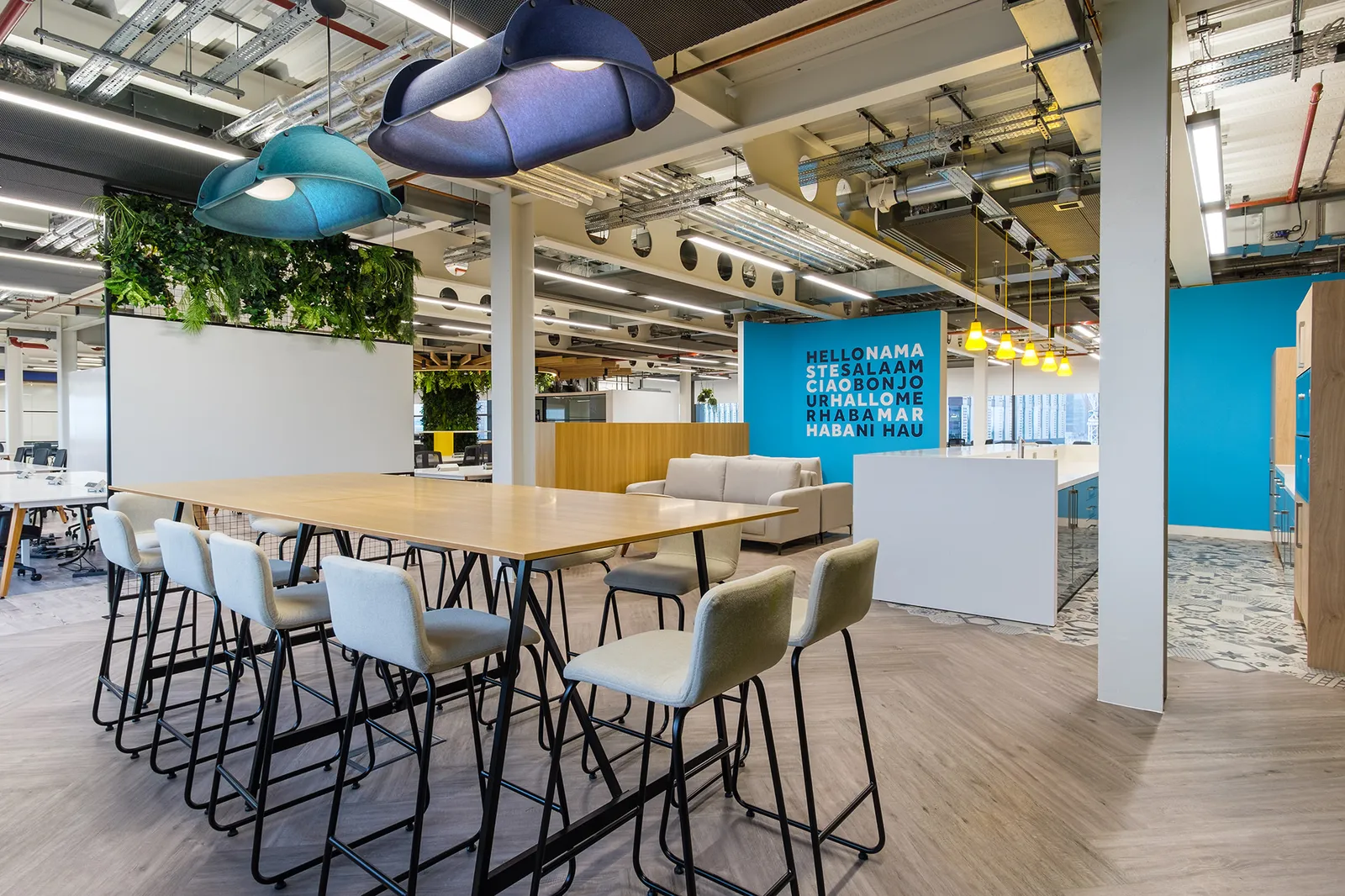 a newly fitted out office with modern furniture including sofas and a high-desk area