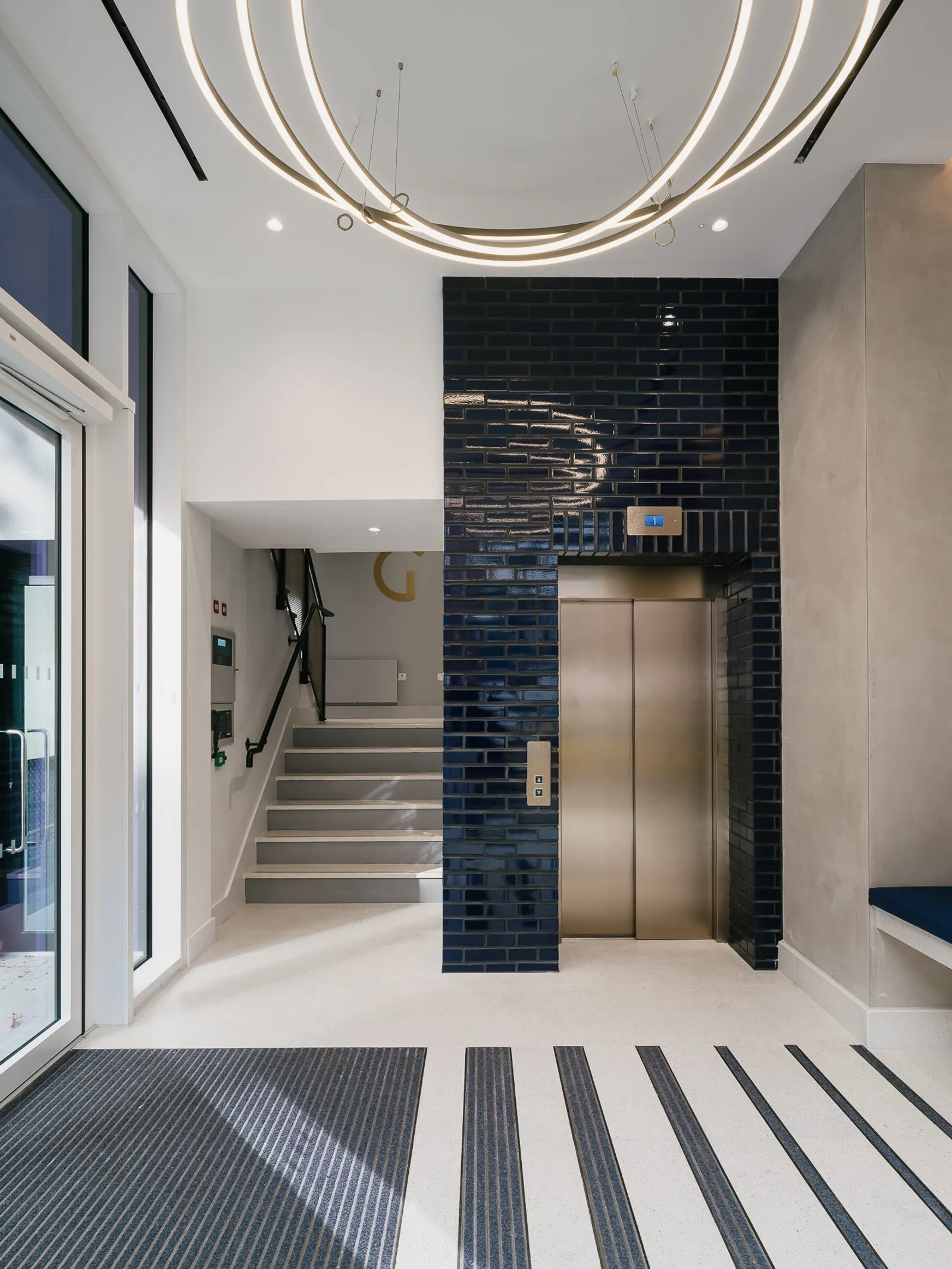 cat a fit out of an entrance area with a lift and staircase