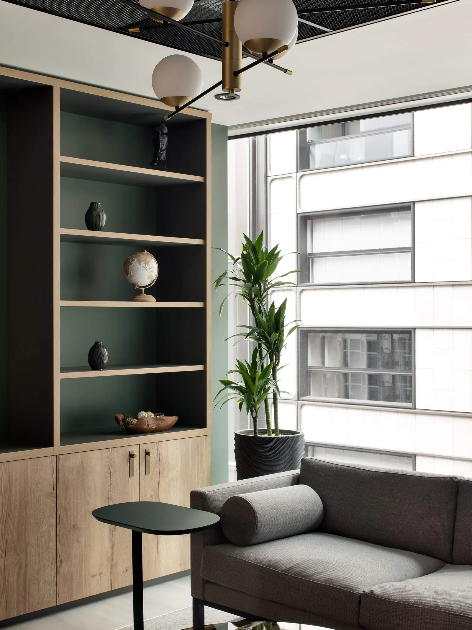 a cat b fit out showing a grey sofa and wooden shelves