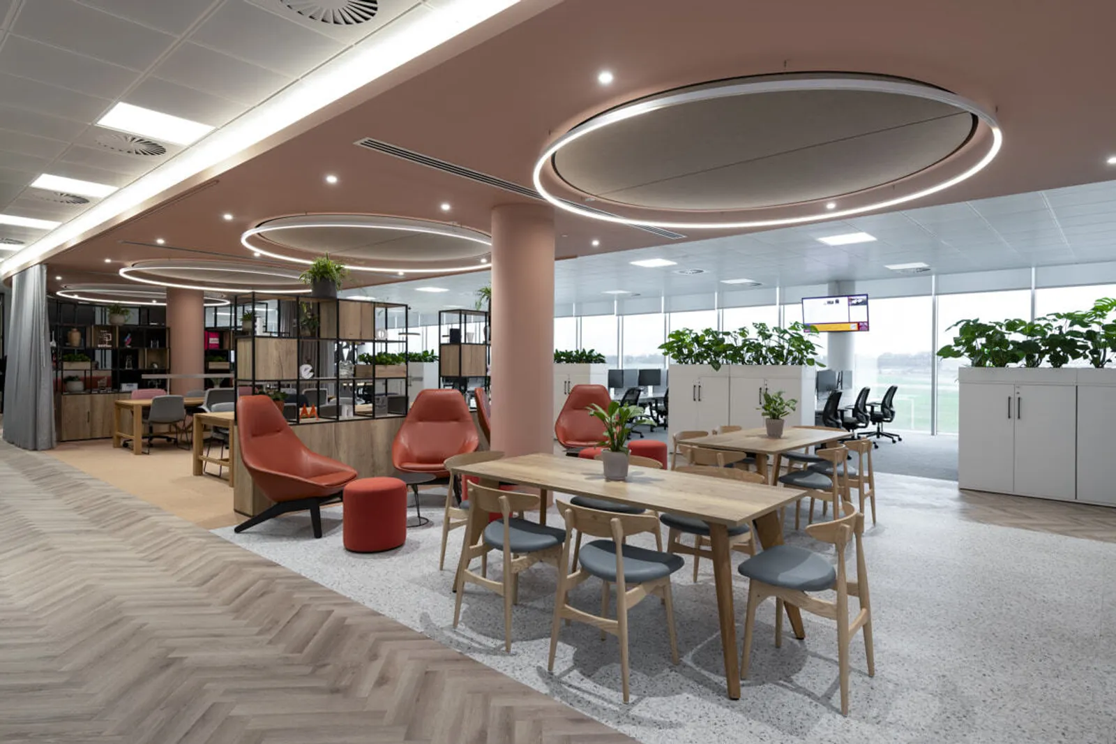 Large open plan office with big windows and relaxed feel